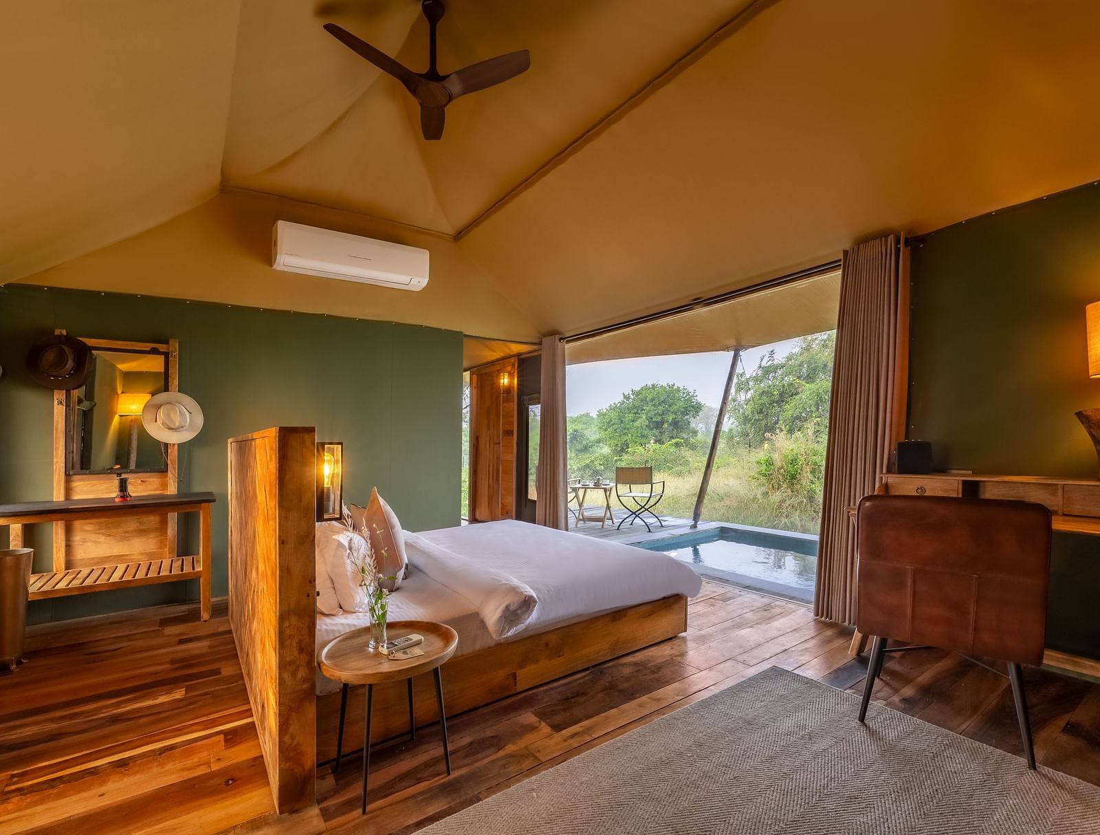 An interior of a room with double bed at Trees N Tigers, Tadoba.