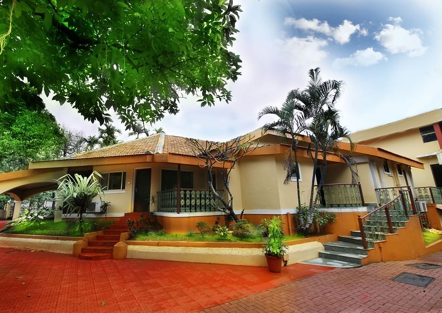 alt-text the exterior facade of the resort surrounded by greenery - Zara's Resort