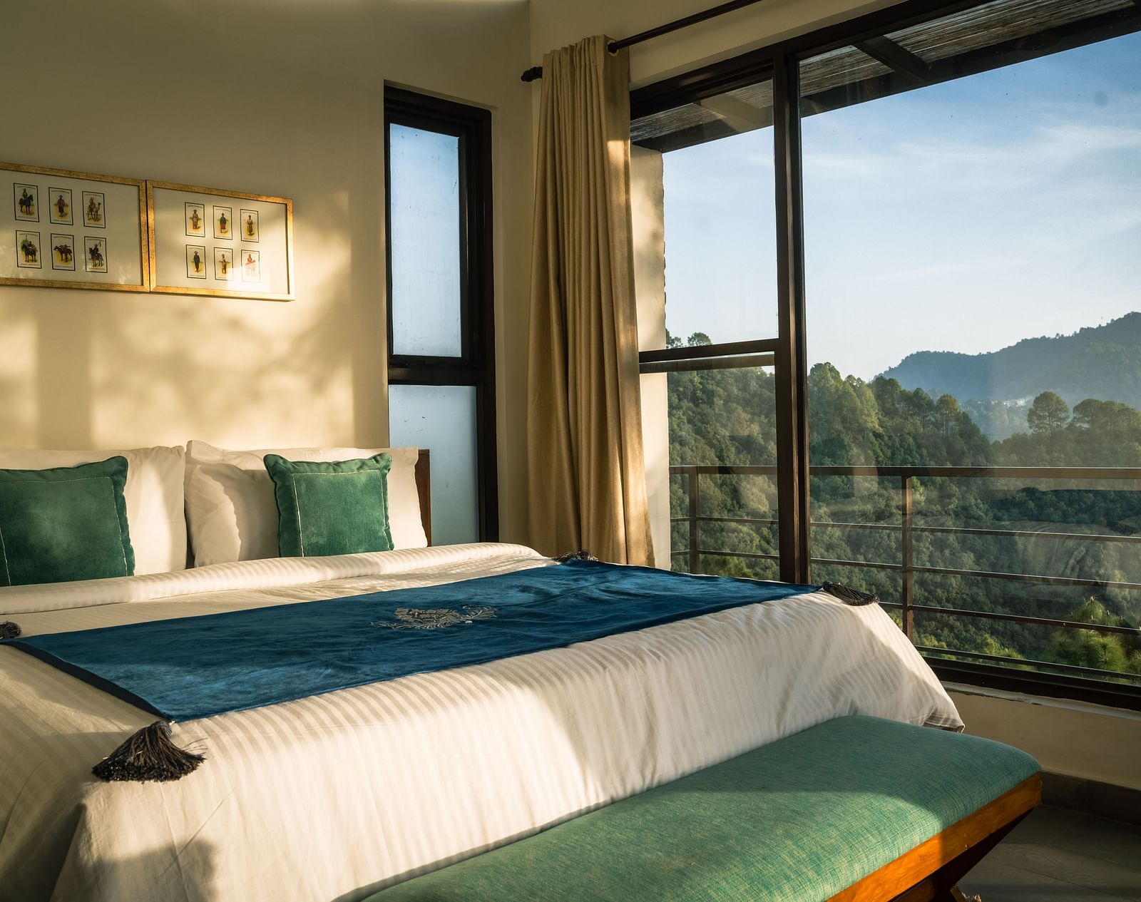 A bedroom with a balcony offering a mountain view and sunlight streaming in at BluSalzz Escapade Resort, Lansdowne