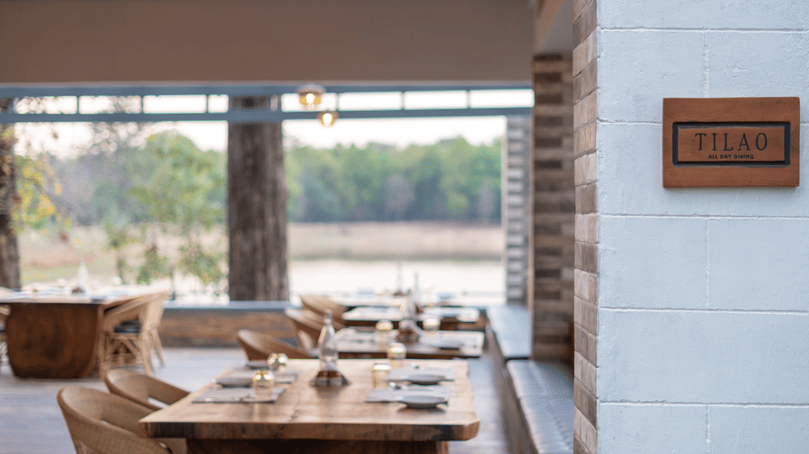 Tilao restaurant with it's name plate on the entrance, and inside it there are several sets of table and chair.