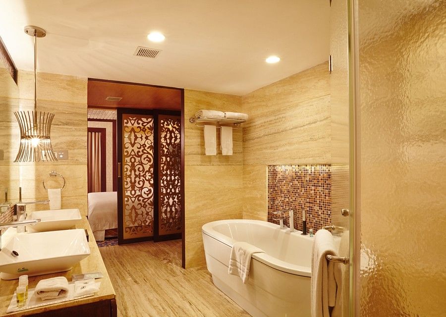 Bathroom of hablis suite with a bathtub and toiletries at Hablis Hotel, Chennai