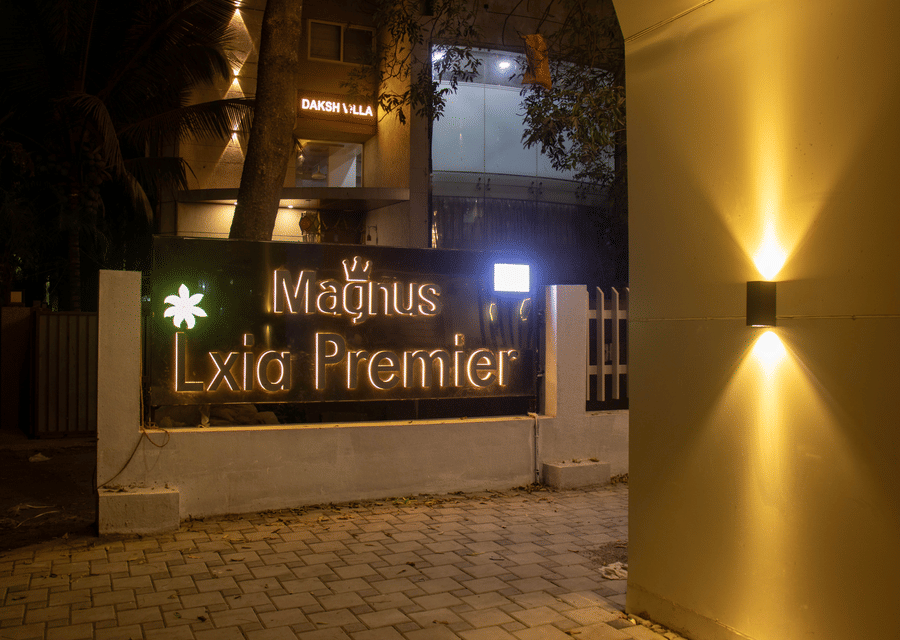The hotel entrance signage and gate area at night at Magnus Lxia Premier, Kalyani Nagar.