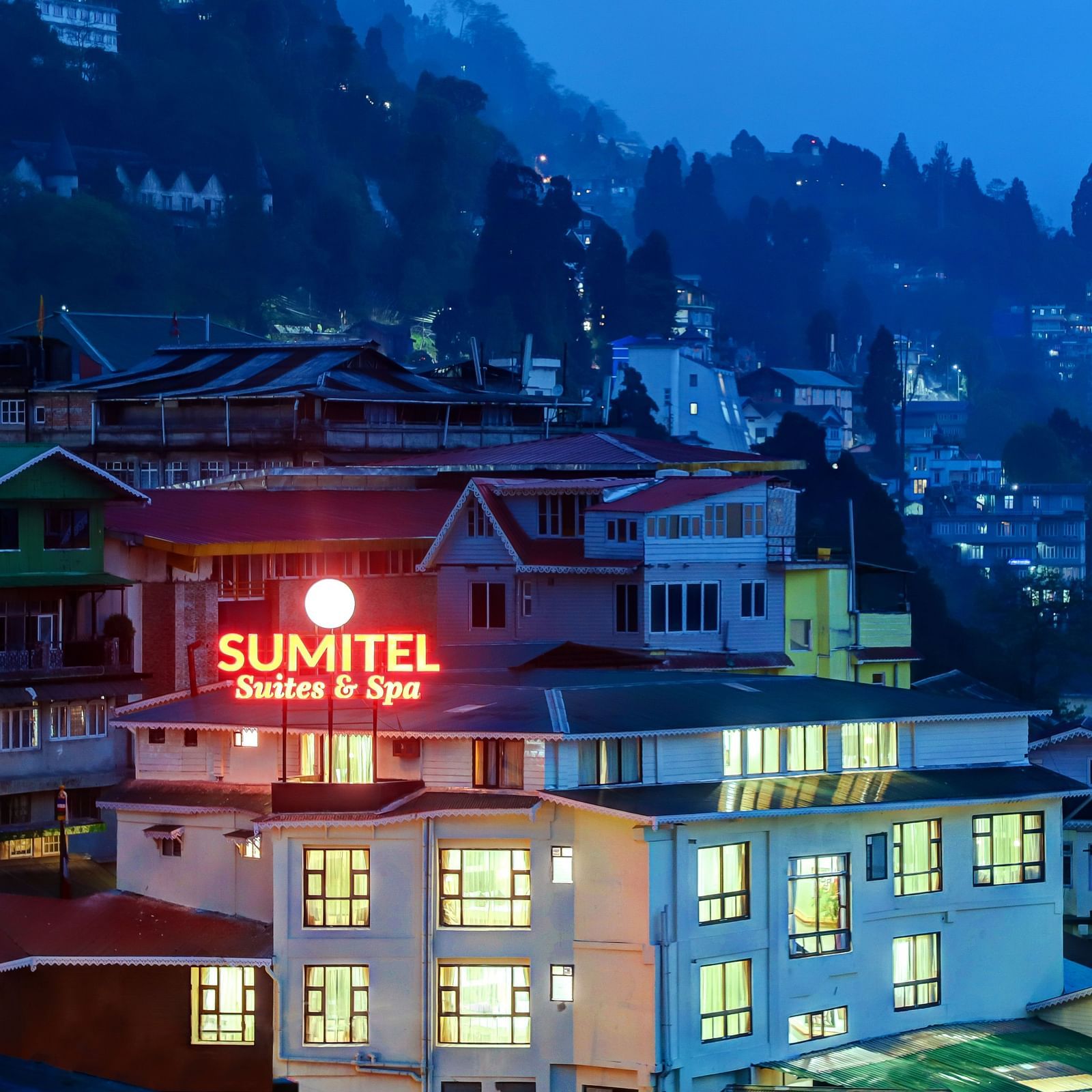 Facade image of Sumitel showing the greenery around and the settlements