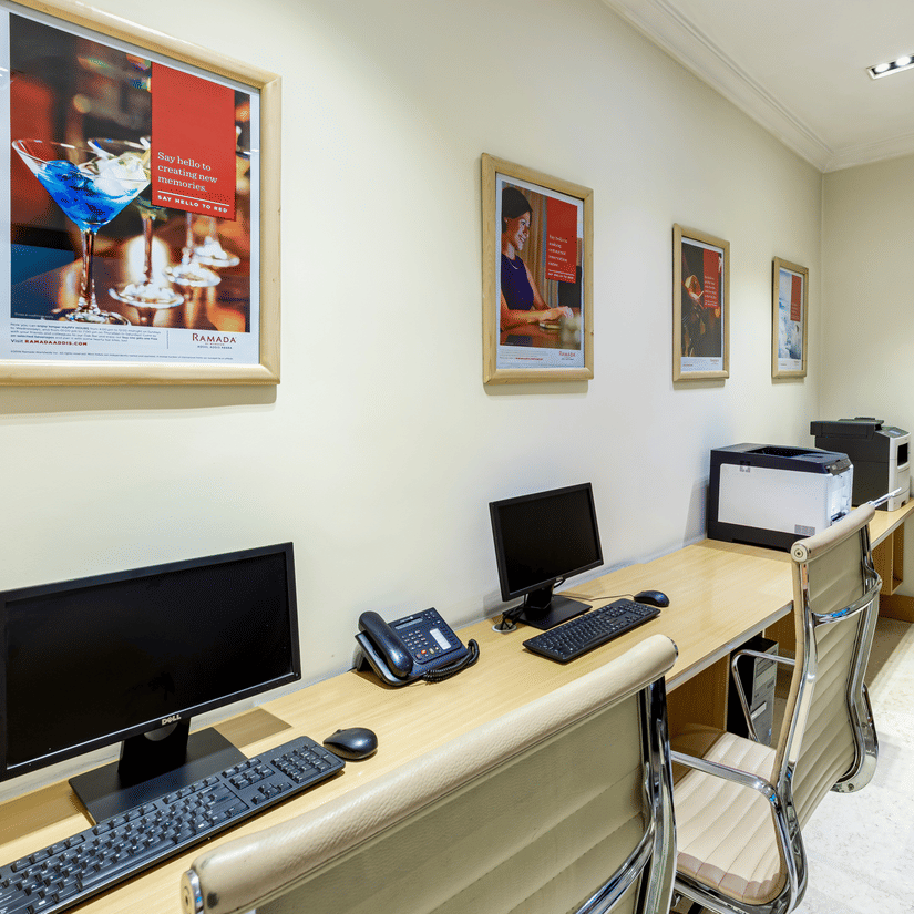 An overview of a room with many desktops, monitors, keyboards and mouse kept on a table - Ramada by Wyndham Addis, Addis Ababa