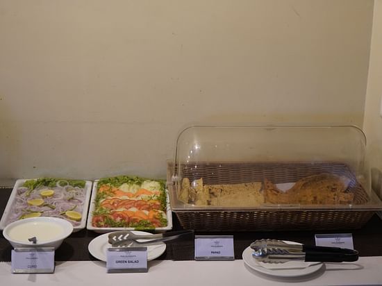 An image of buffet area featuring vegetable salads and breads at the restaurant of Five Elements Hotels North Avenue, Delhi