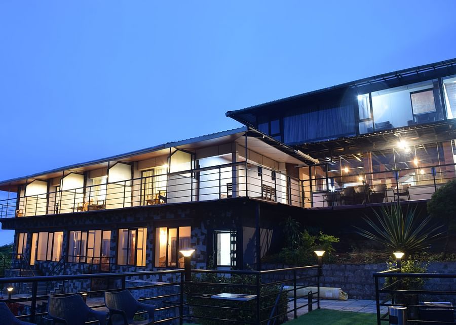 A night shot of the facade of the resort with blue sky in the background | Ibex Stays and Trails