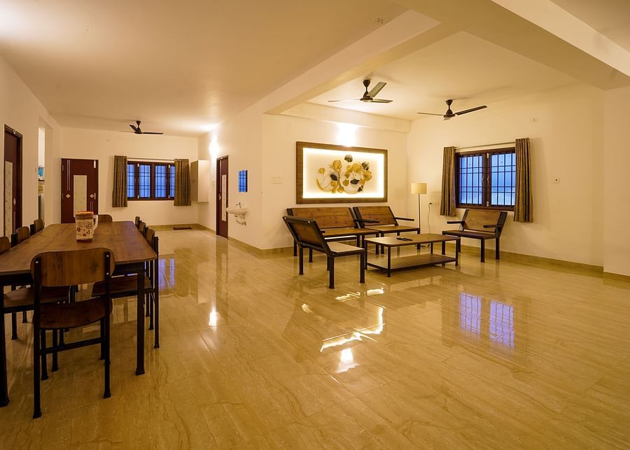 alt-text Living area with seating arrangements of sofas and coffee table and dinign area inside Superior Villa - La Tamara Luxury, Pondicherry