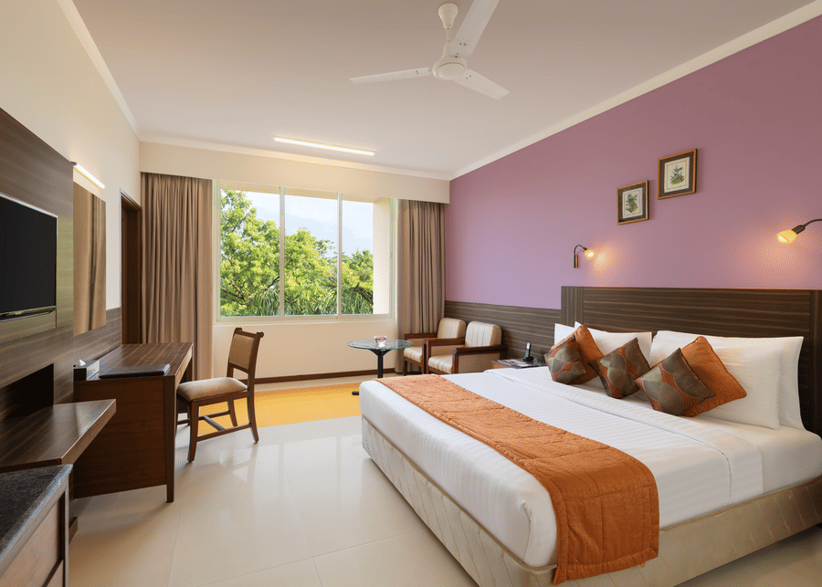 alt-text Room with a double bed and a television - Sangam Hotel, Thanjavur