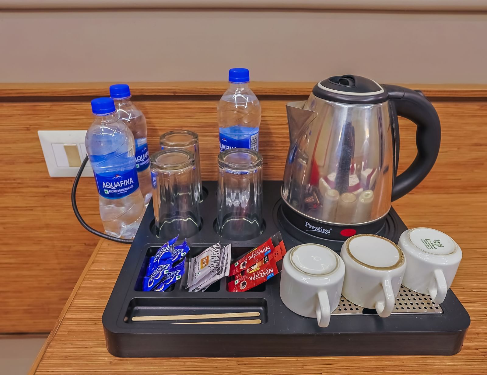 ea and water setup with cups and snacks at Max Hotel Prayagraj.