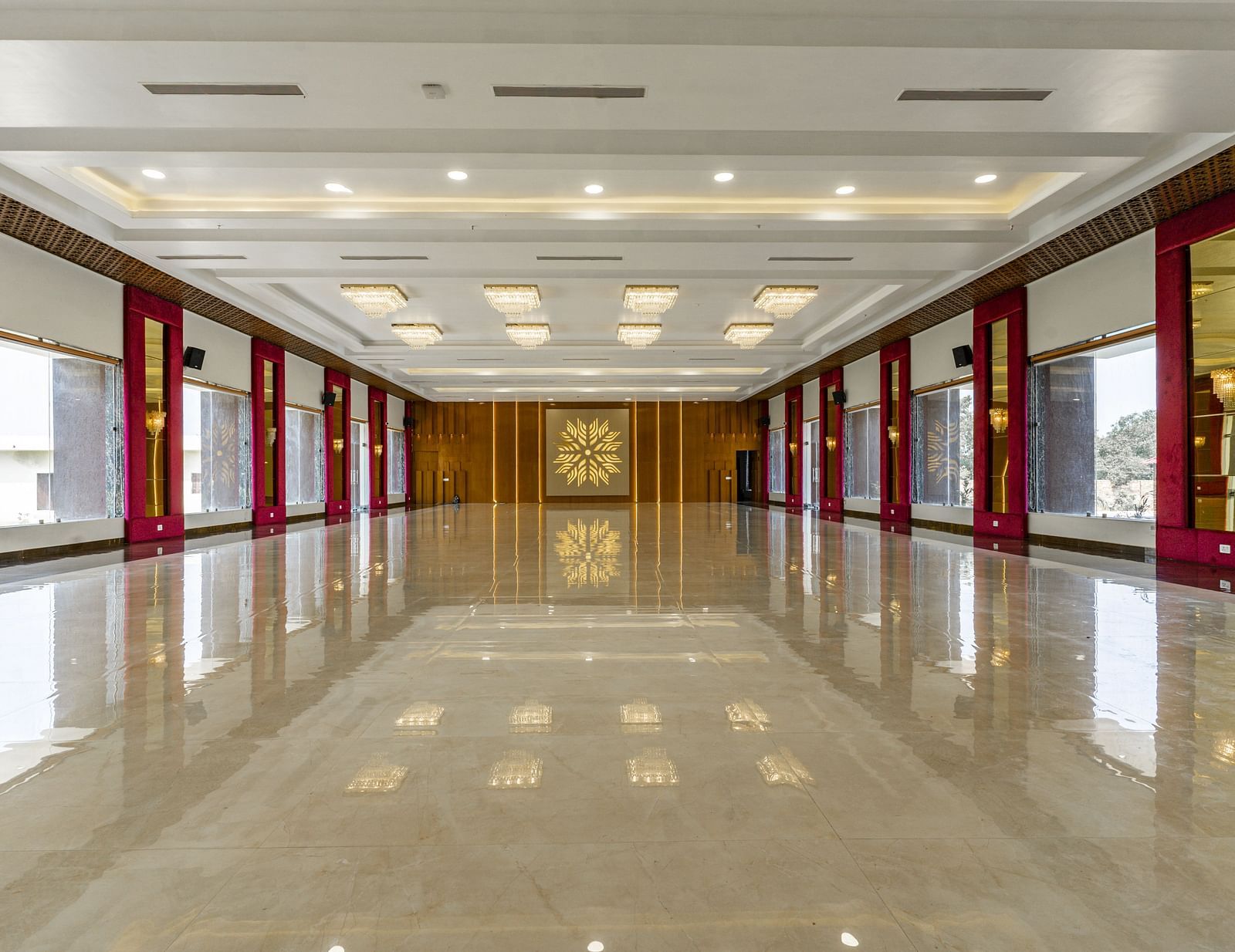 A long, empty hallway with a highly polished floor that reflects the ceiling and walls - Bamboo Saa Mulberry Resort, Pushkar