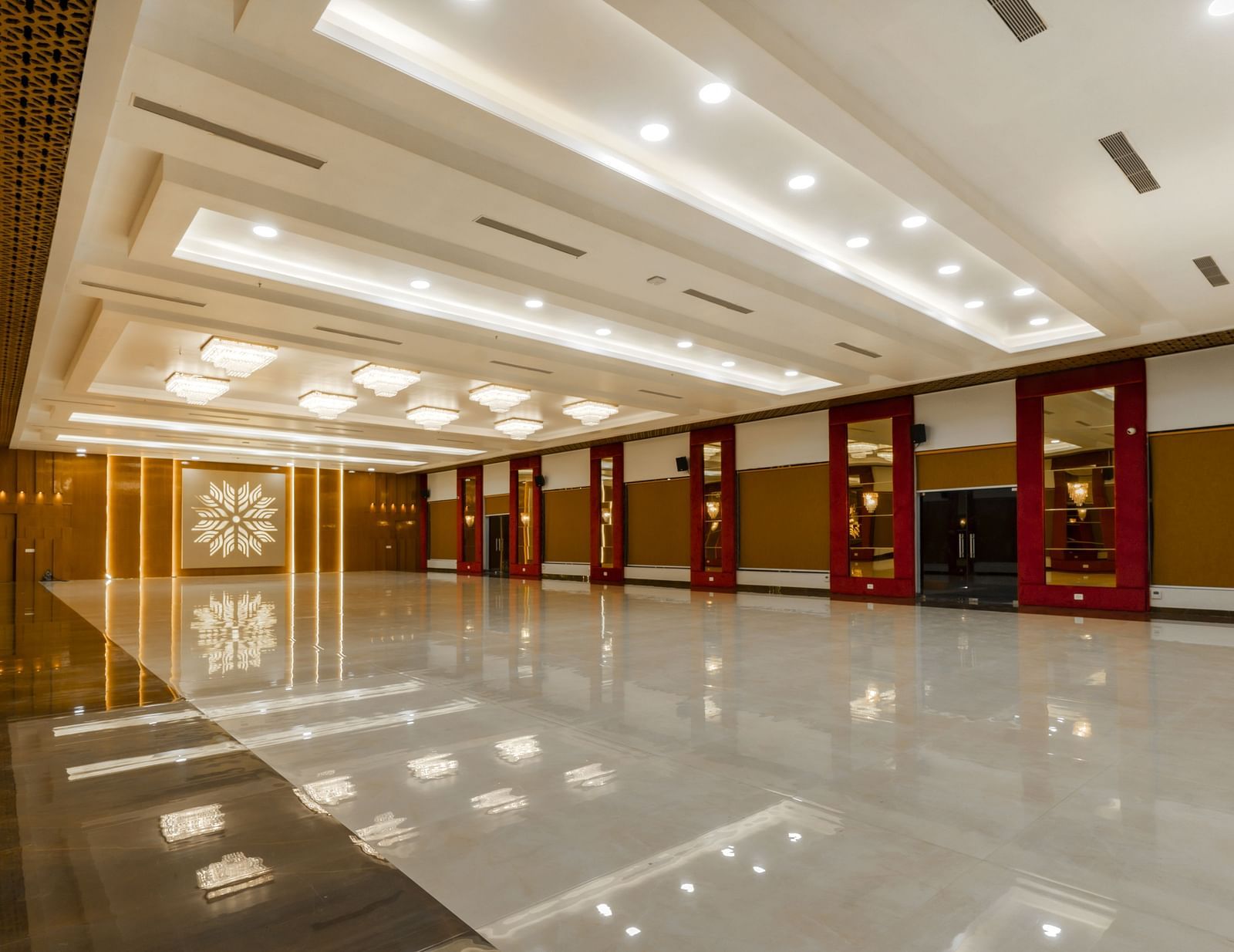 An angular shot of a long, empty hallway with a highly polished floor reflecting the ceiling and walls - Bamboo Saa Mulberry Resort, Pushkar