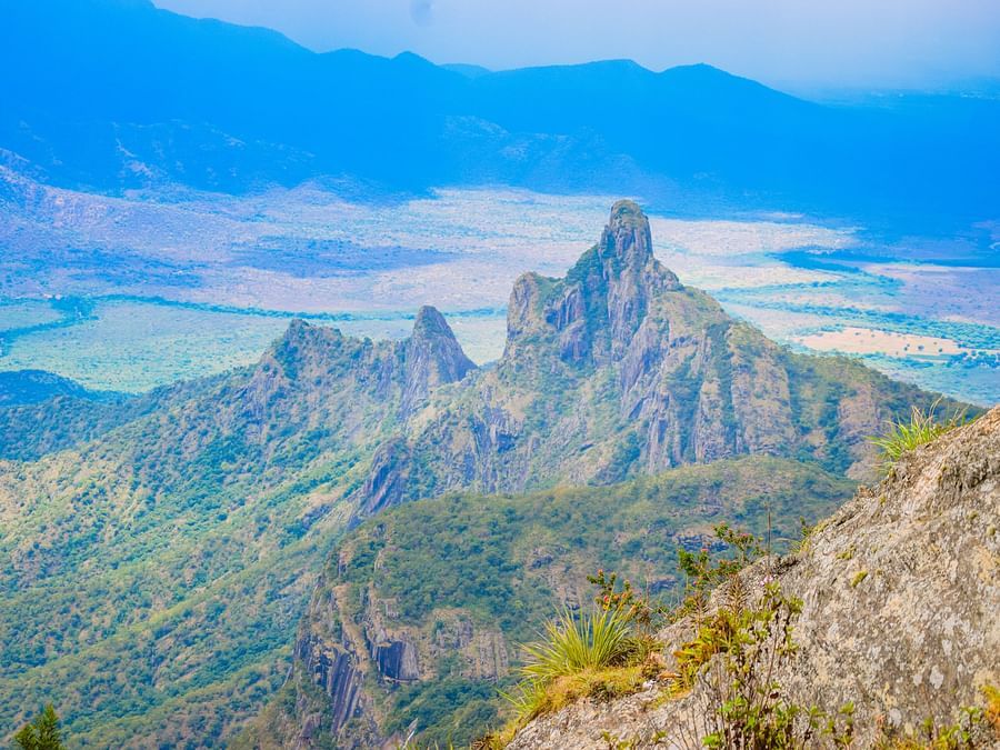 view from the top of a mountain of Kotagiri with tall green mountains in view