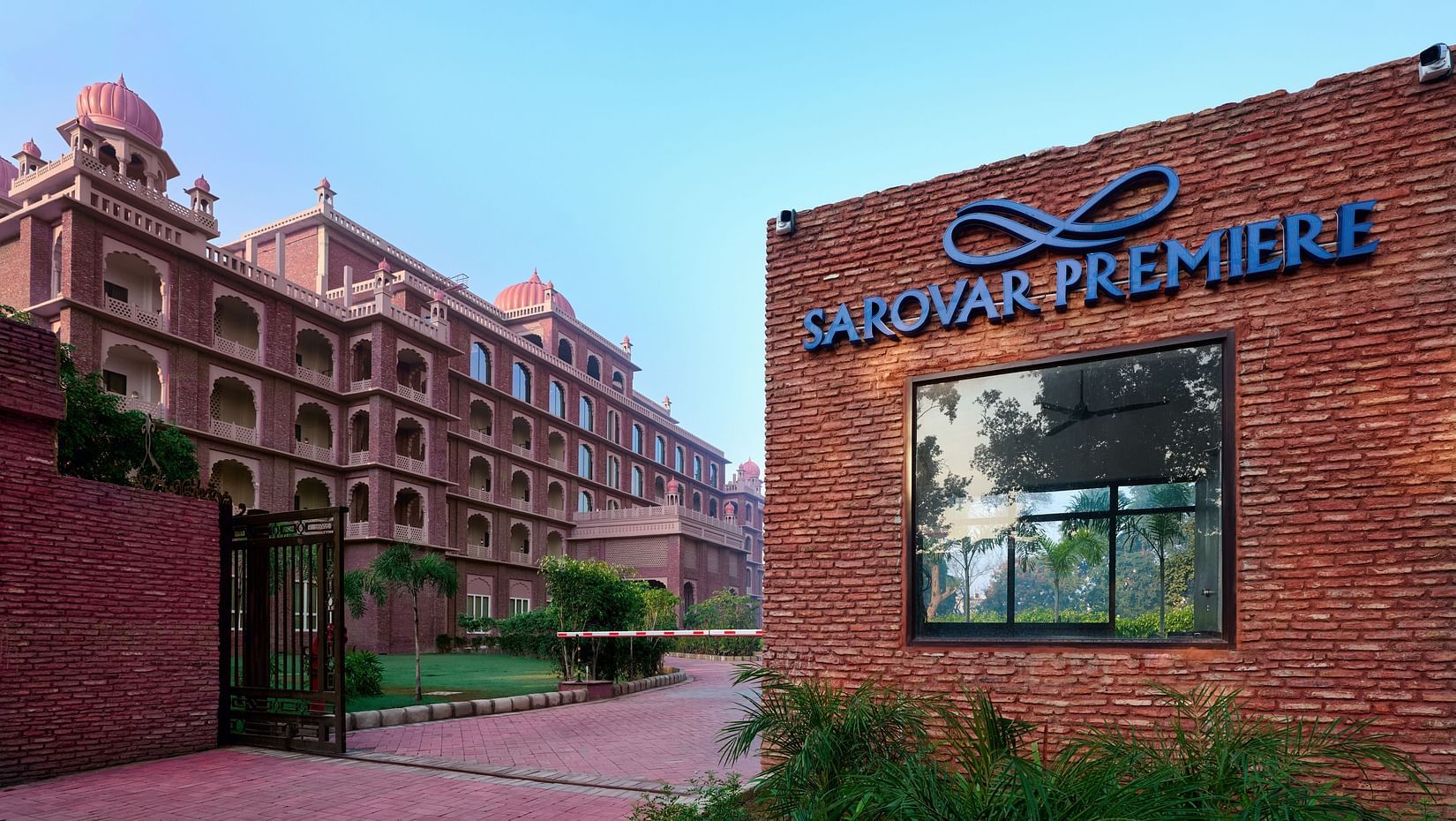the entrance to our Amritsar hotel with a signboard reading the name of the hotel - Sarovar Premiere Amritsar