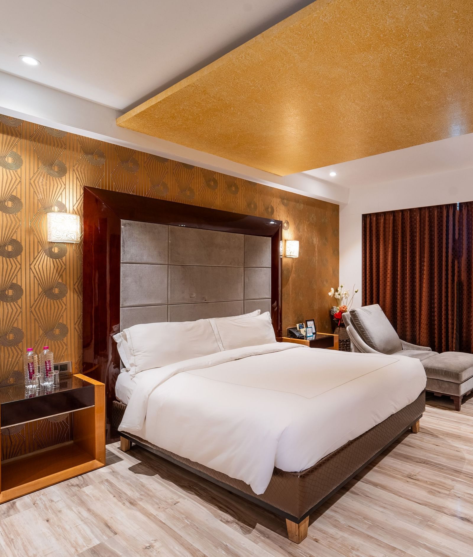 Family Suite includes a spacious bed with a bedside table, large windows with curtains, and a wall-mounted television at Crescent Spa & Resort, Indore
