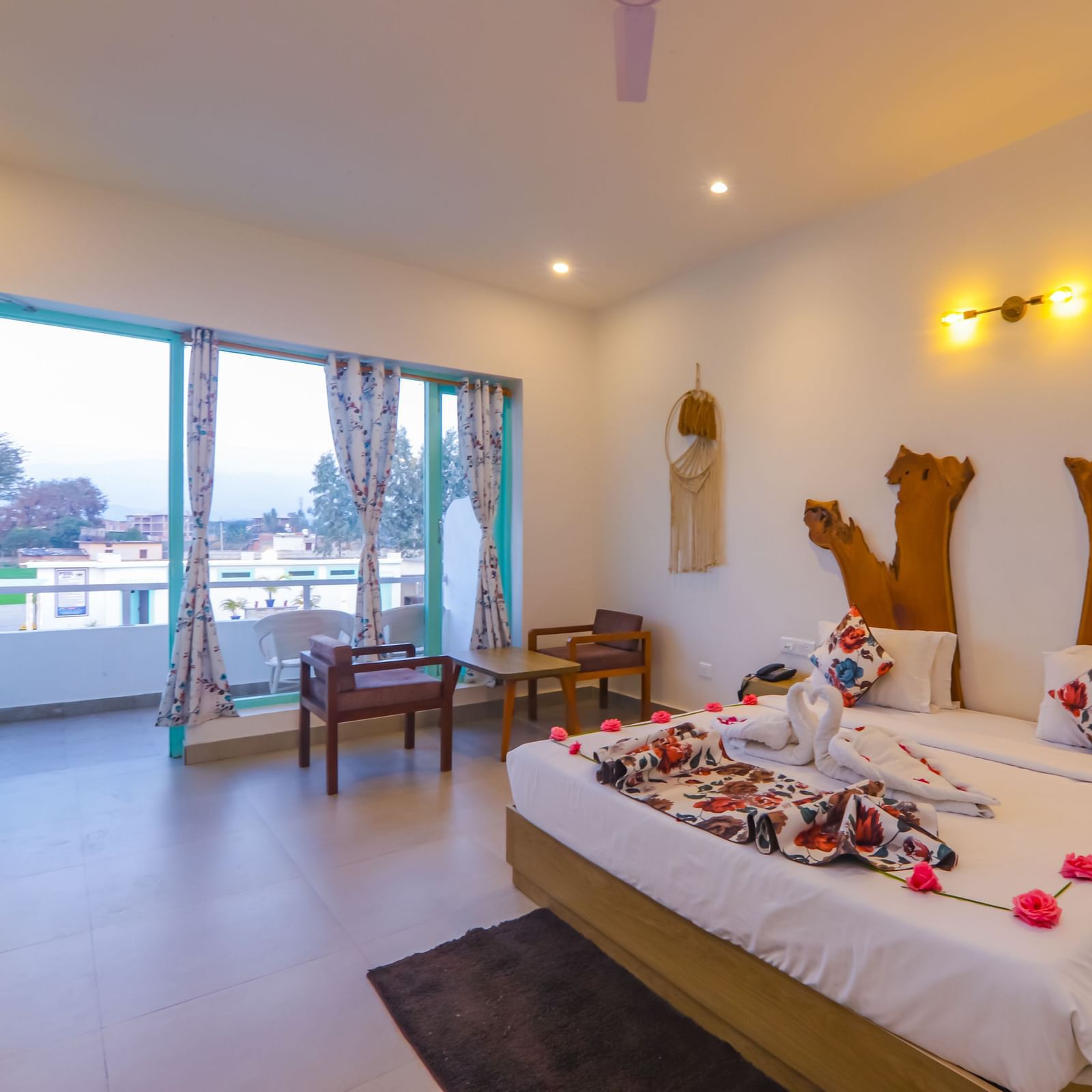 A uniquely decorated bedroom at Vedikant Resorts The Mallard Corbett features a bed adorned with flowers and seating.