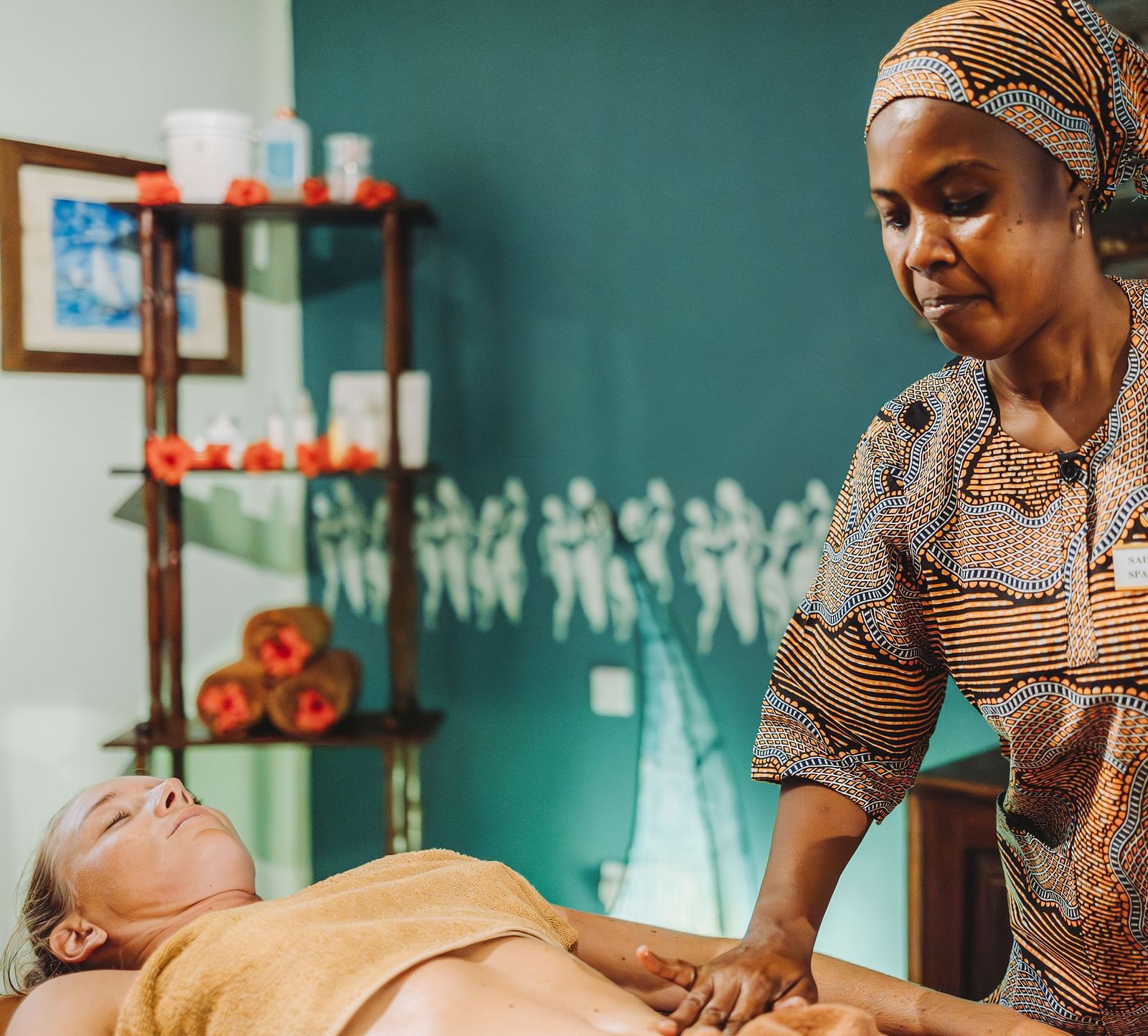 A professional spa therapist giving a relaxing massage to a client in a well-decorated spa room at Shooting Star Boutique Hotel