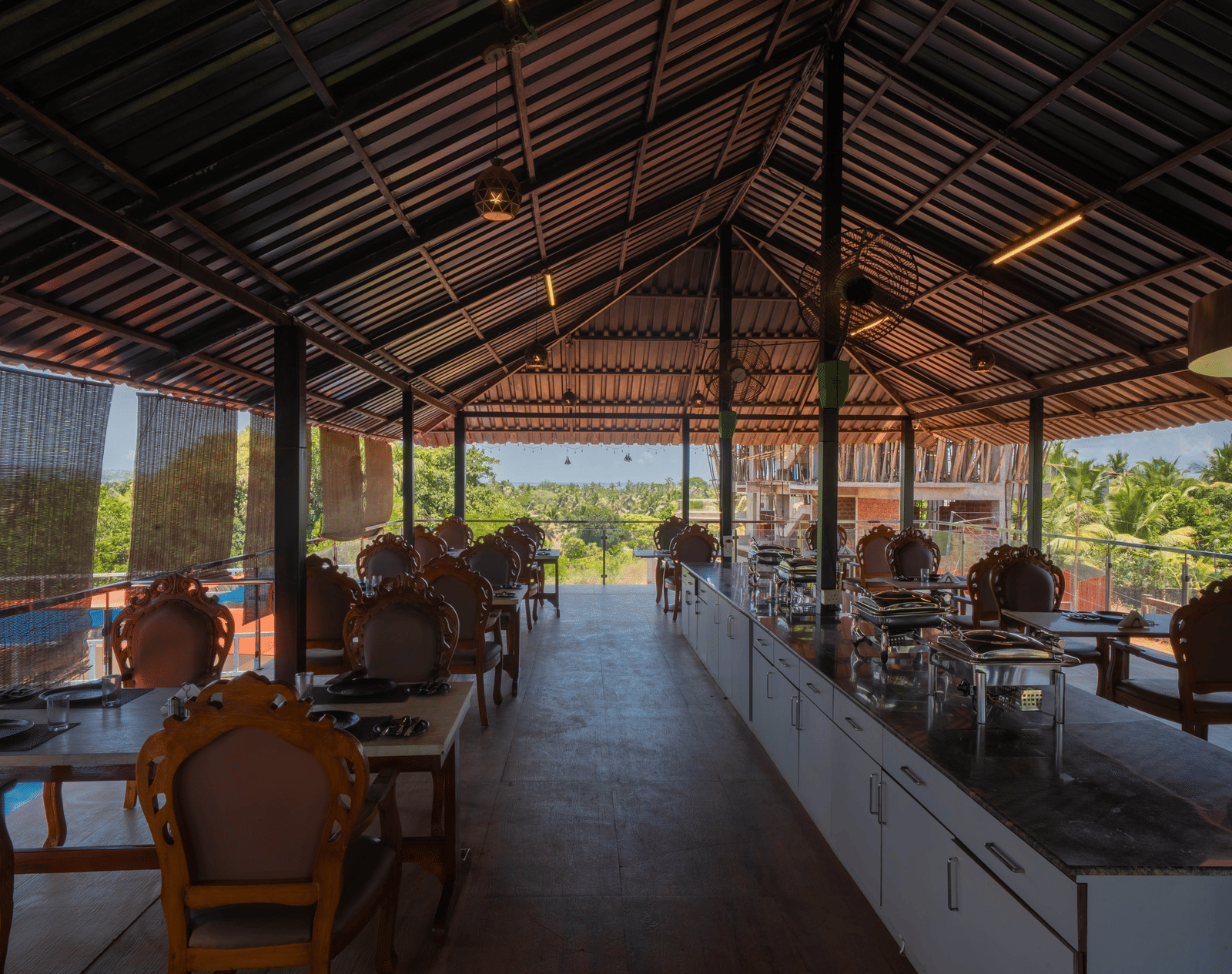 Our restaurant in Goa featuring 4-person seating tables and a buffet counter at the centre - Perfectstayz Koko Maya