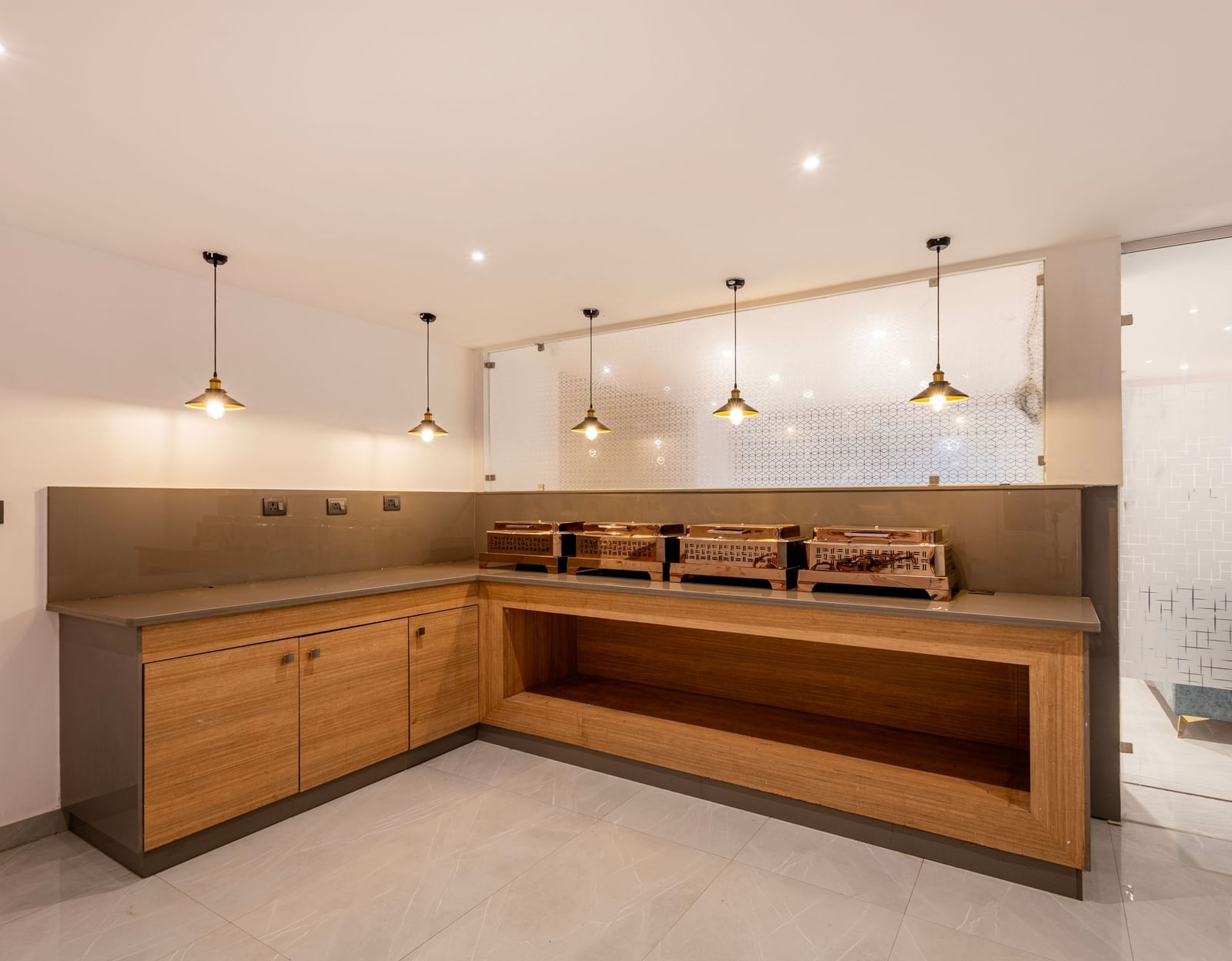 A modern buffet area wooden counter and contemporary pendant lighting - Beestay Hotels Financial District, Hyderabad 