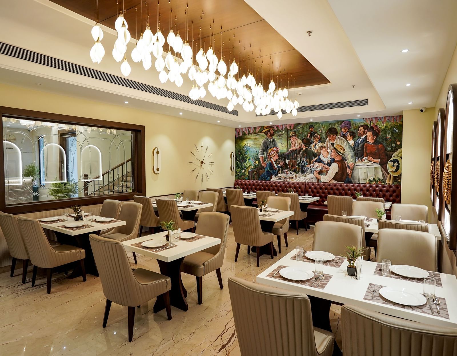 A wide angle shot of the Mosaic restaurant featuring a brightly lit dining area with modern interiors and well arranged tables at M2 Square by Monday Premium.