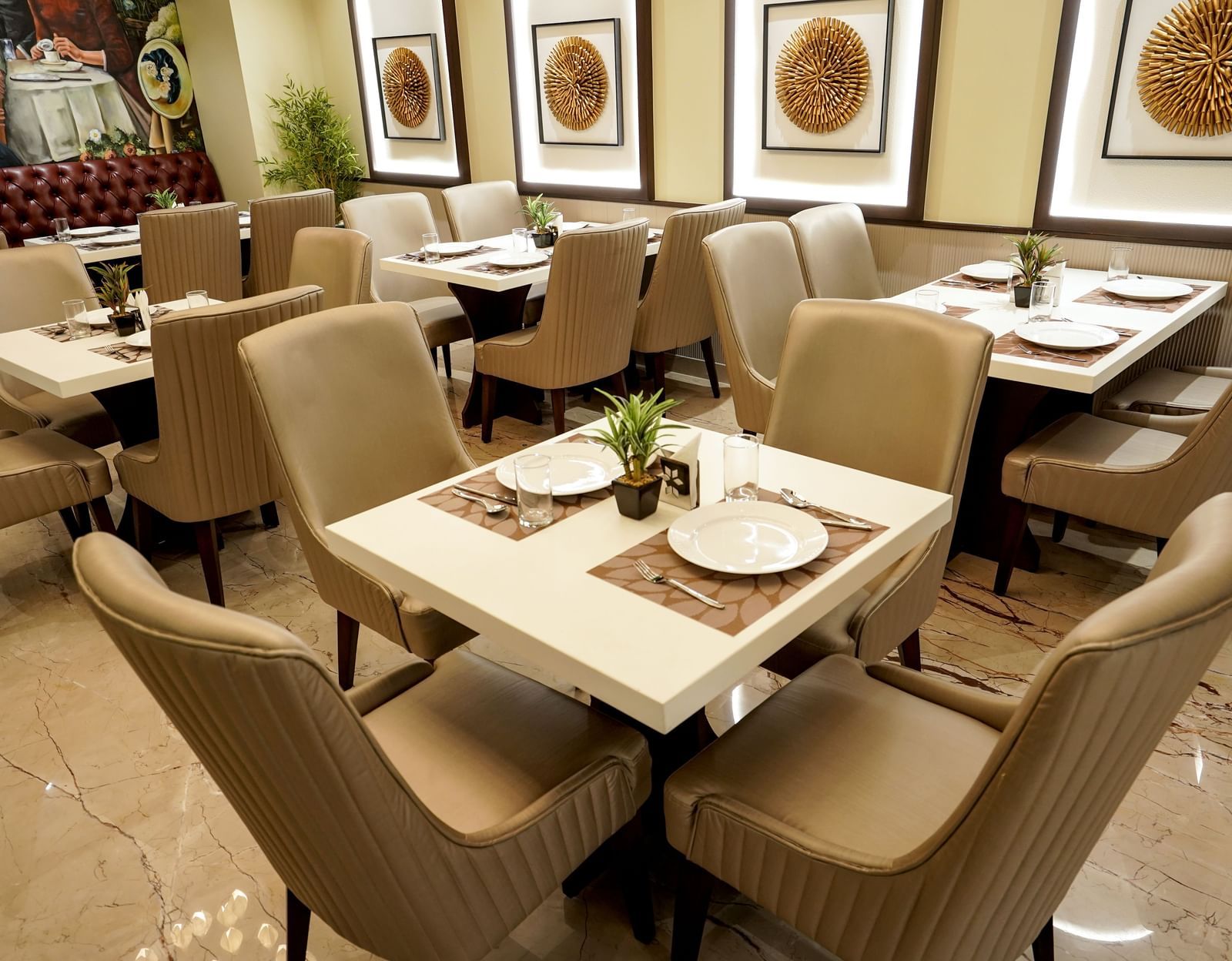 A close-up shot of a 4-seater dining table at the Mosaic restaurant featuring 2 plates on the table.
