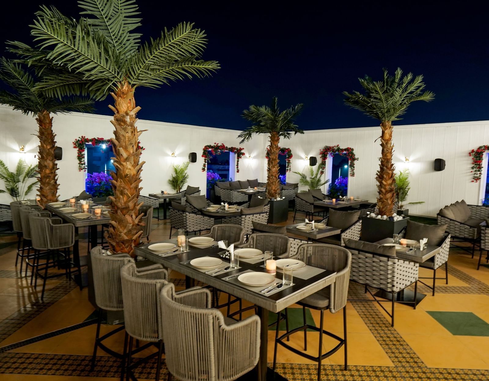 Corner view shot of the Sky Roof featuring well arranged dining tables along side several trees at M2 Square by Monday Premium.