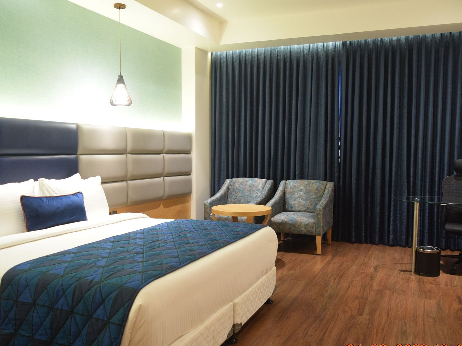 A comfy premium room with king size bed , chair at SRM Hotel Maram Malai Nagar, Chennai