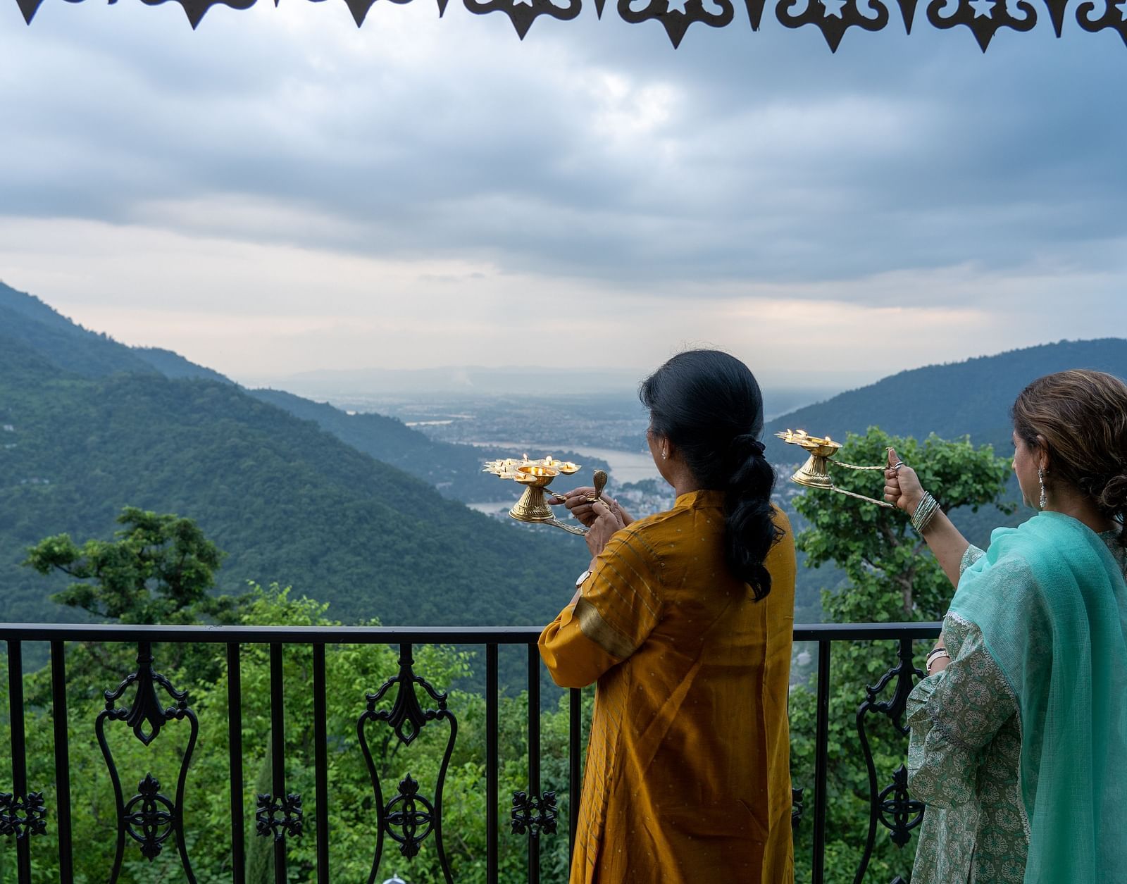 two women doing ganga aarti at Neer Ganga Resorts