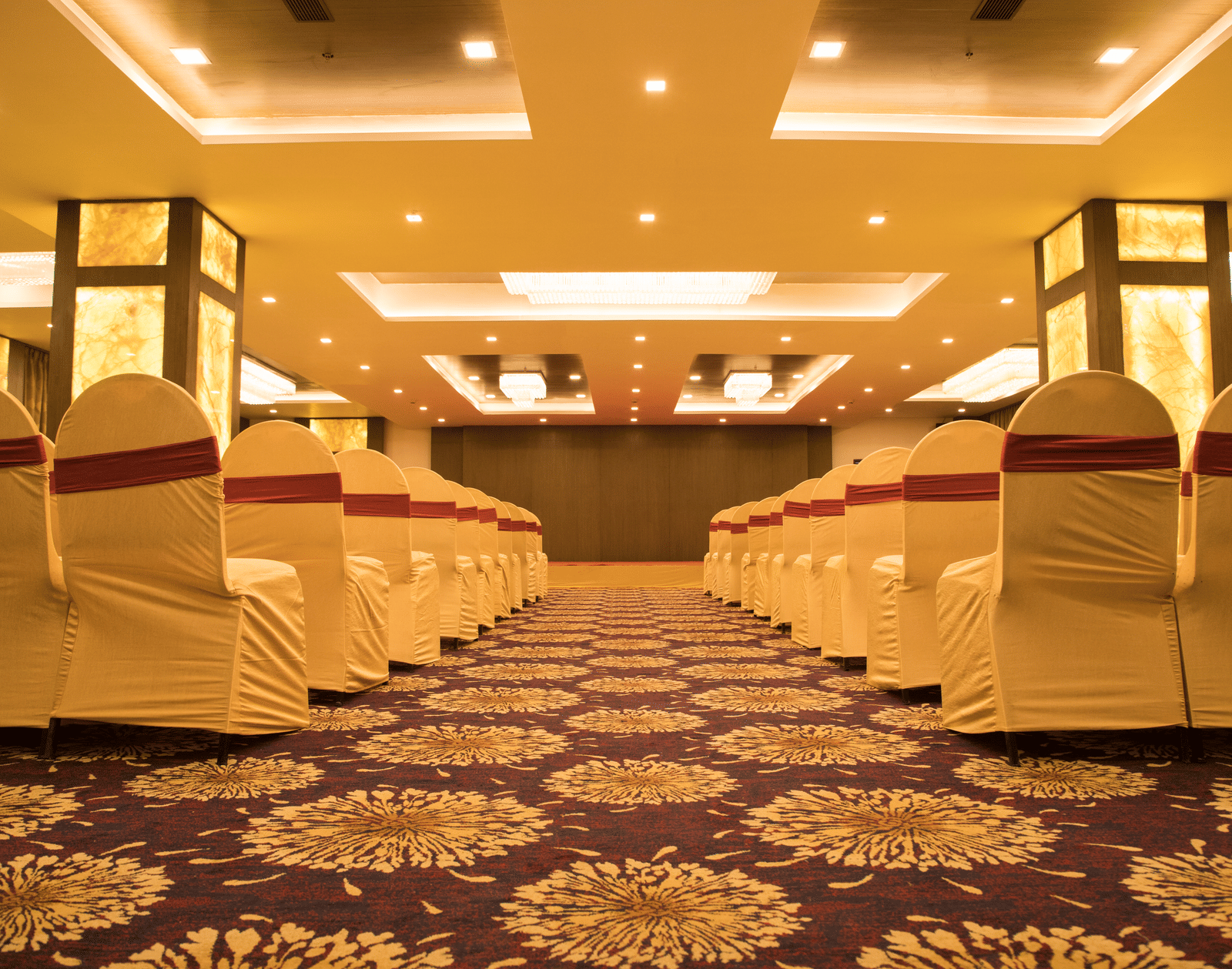 A conference or event room at Benzz Park Chennai with rows of chairs facing a central aisle.