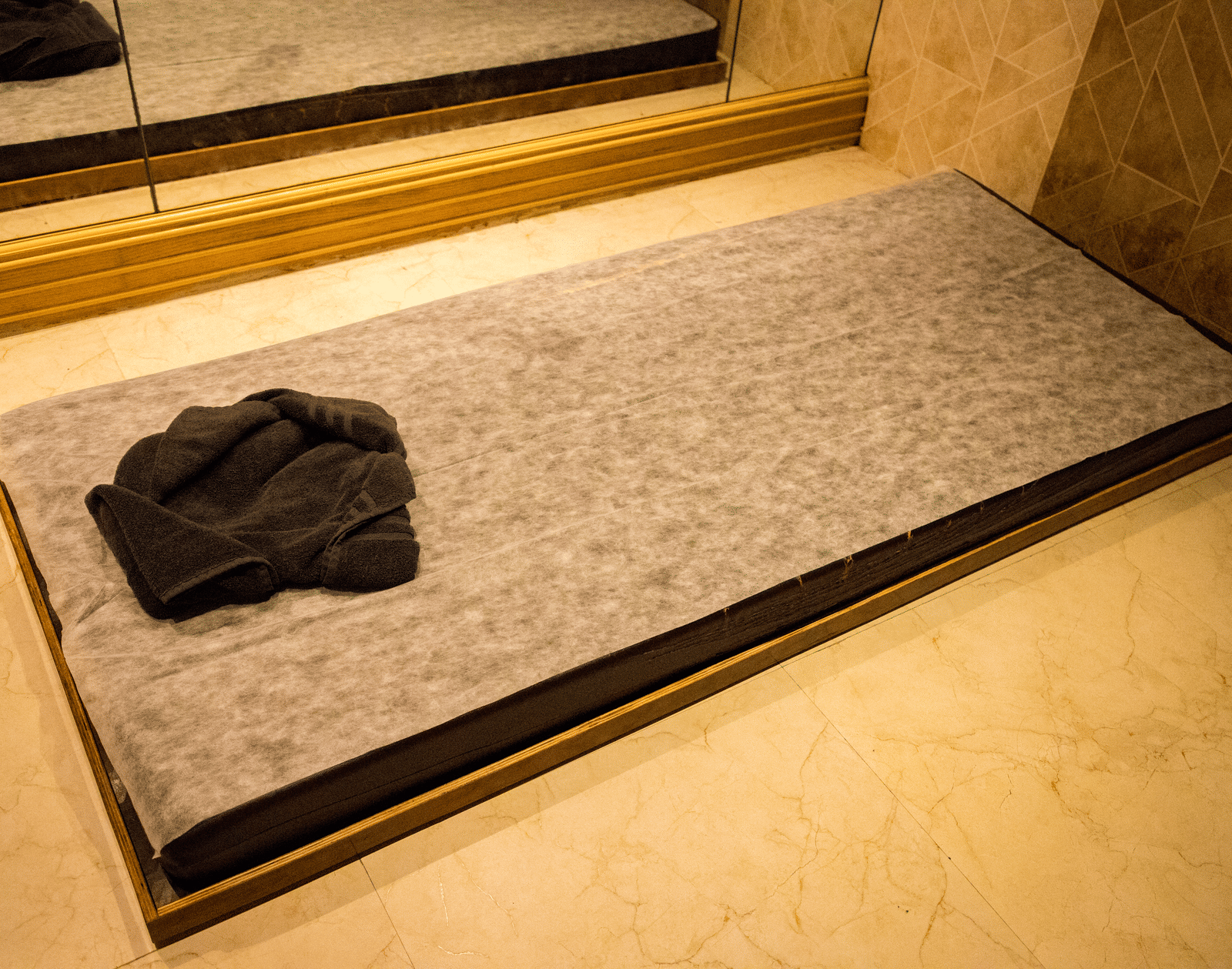 Top view of the mattress kept on the floor with a towel placed over it at the Benzz Park, Vellore.