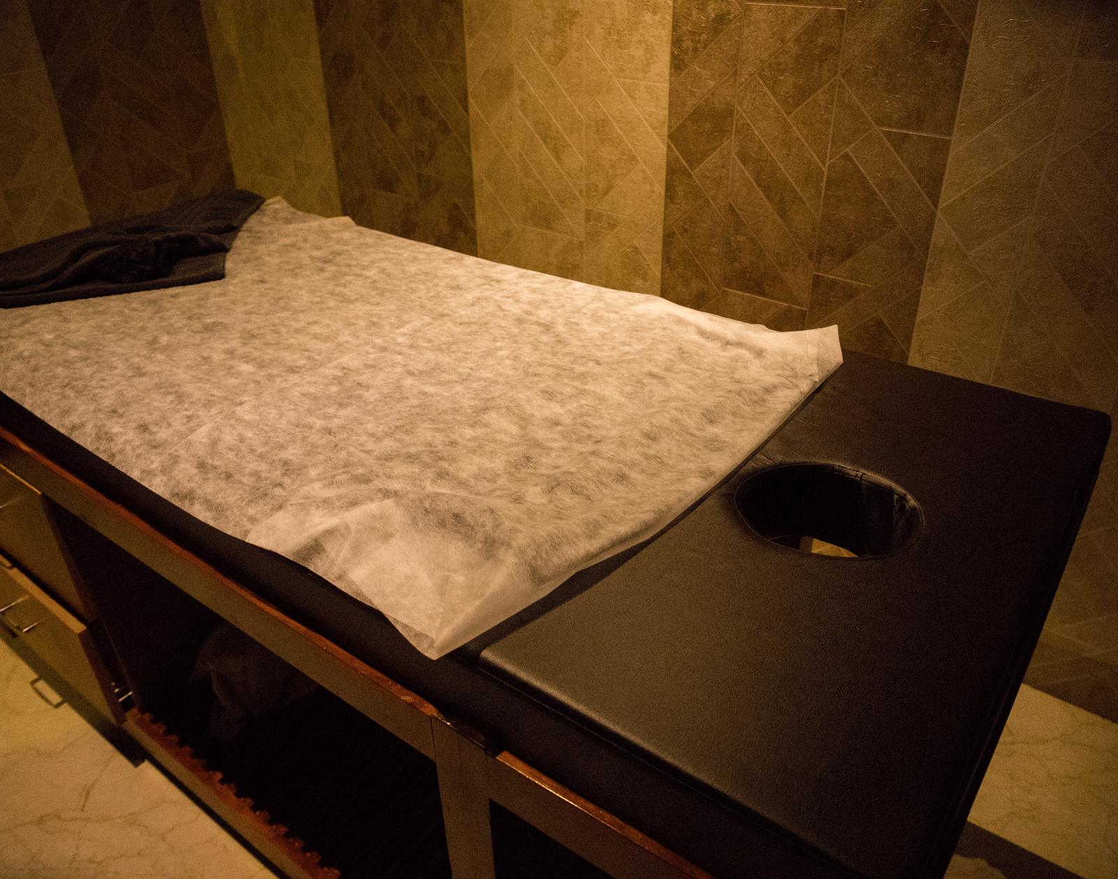 Close up of the spa bed at the Benzzee O2 Spa at the Benzz Park, Vellore, featuring a towel spread over it.