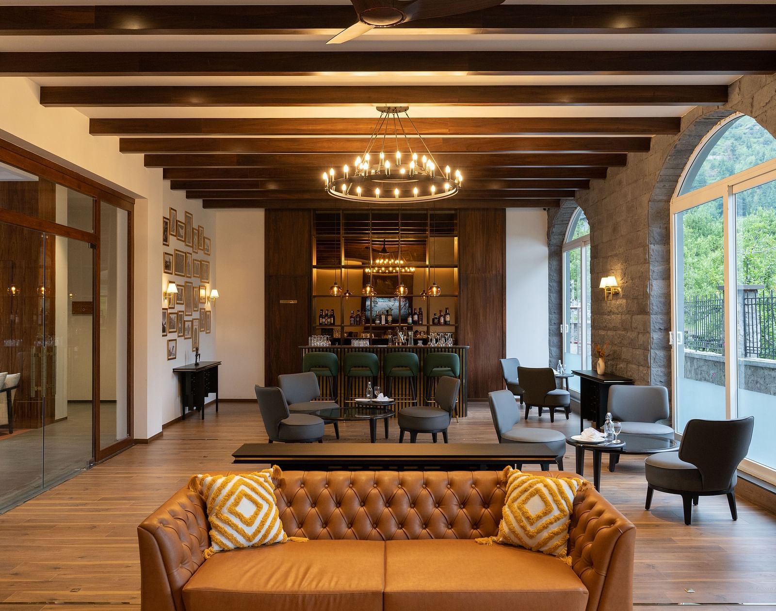 Warm lounge with mustard sofas and soft natural light at Nivasana Manali.