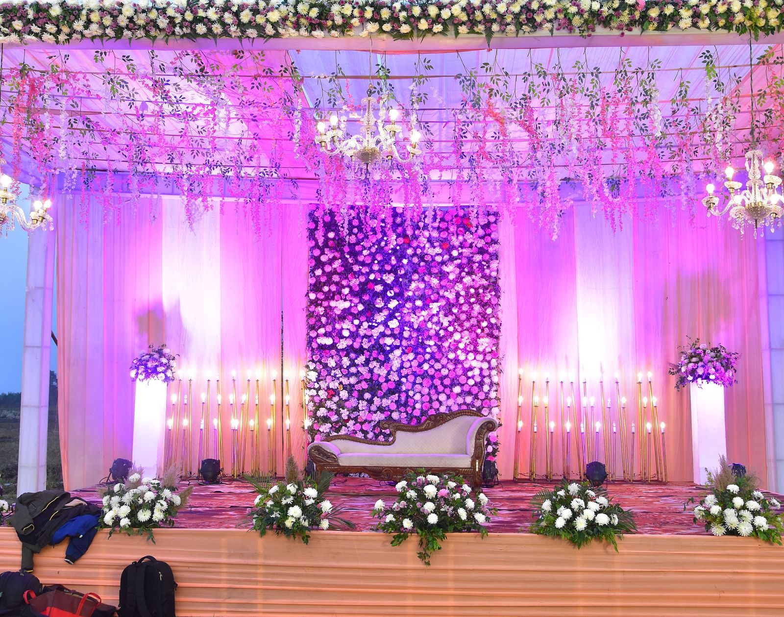Grand wedding stage with pink floral backdrop at Vedikant Hotels & Resorts.
