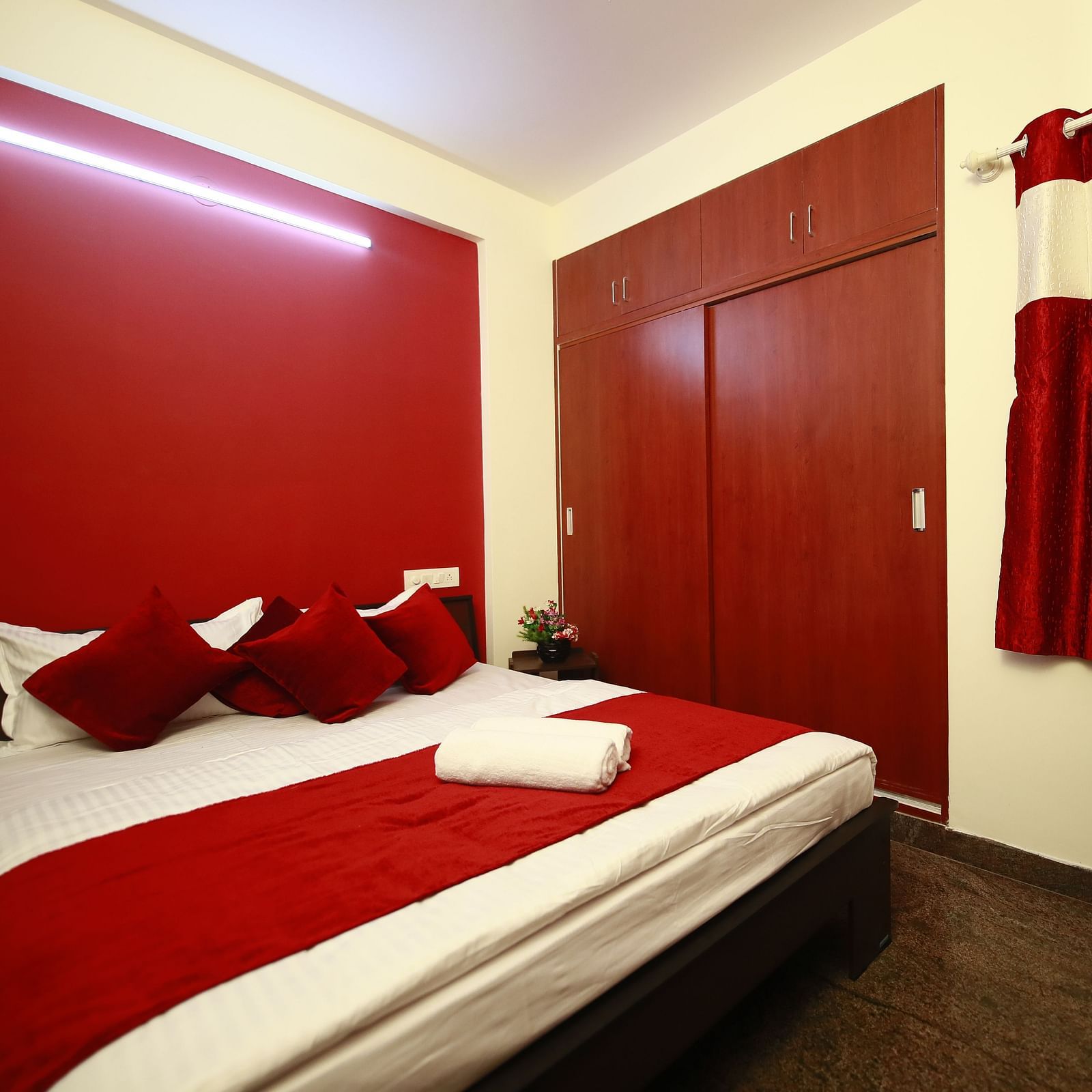 A queen size bed in a room at Tranquil ABS Orchid Serviced Apartments