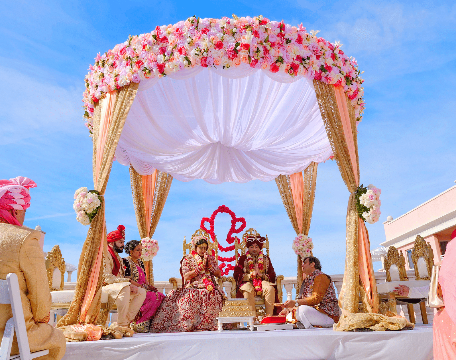 Image featuring floral wedding setup, with a few people in the event in day time.