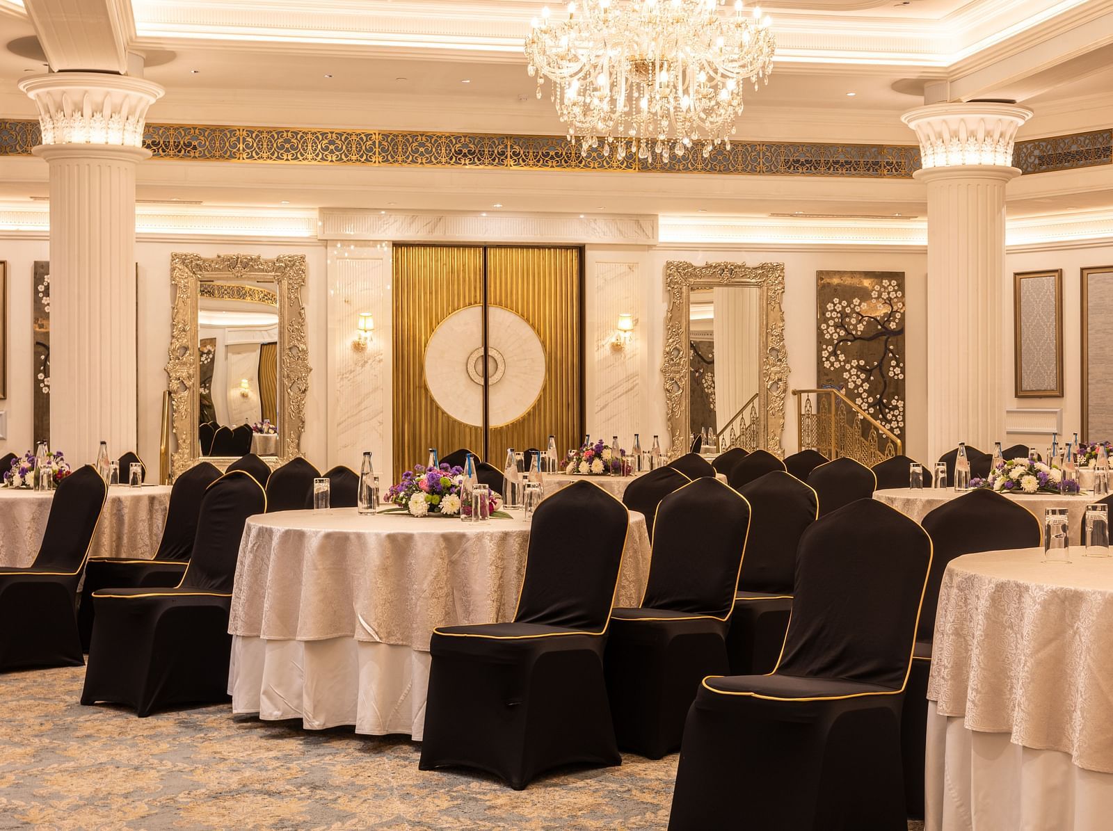 Image featuring the Viceroy Hall event venue at The Claridges New Delhi, showcasing seating arrangements and an elegant chandelier hanging overhead