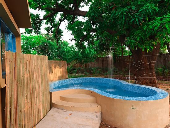 Image of a small pool in an open space at Themis Mudhouse- A Nature's Wellness Resort