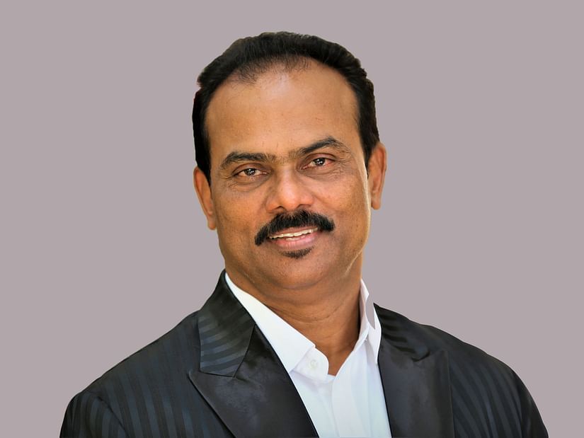 Rajasekharan Nair, Chairman & Managing Director at UDS Group of Hotels in grey background