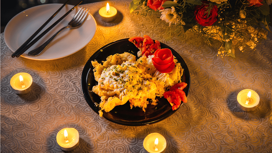 Fried starter topped with creamy sauce and spring onion, garnished with a carved tomato rose, served by candlelight at Ajito, Ilara Hotels & Spa, Tada.