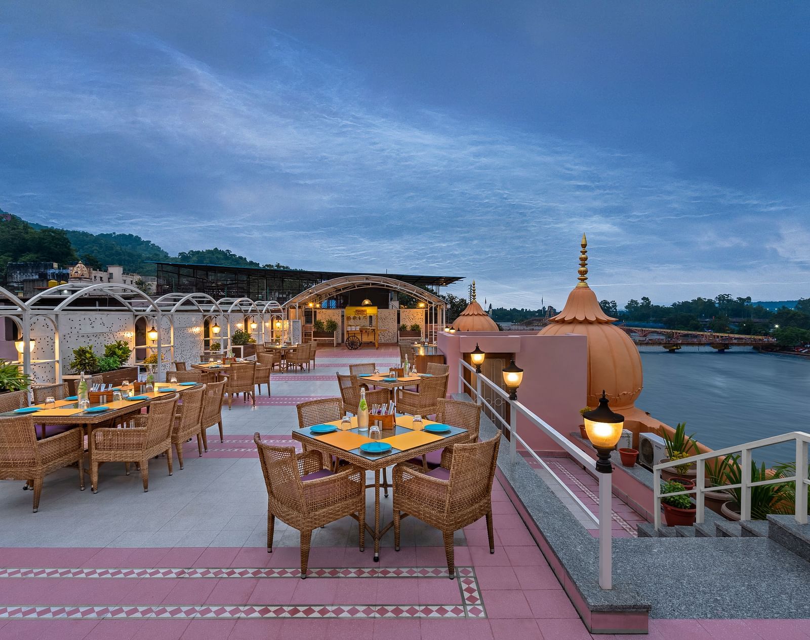 Outdoor seating at The Patio rooftop café overlooking the Ganges river near Har Ki Pauri, Haridwar.