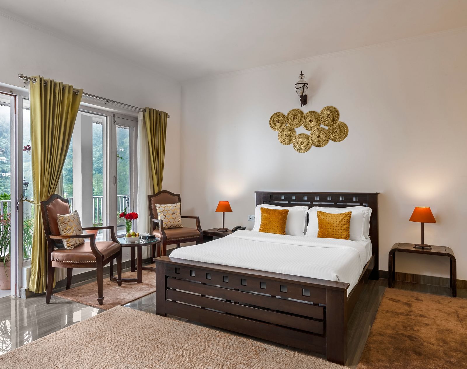 Spacious bedroom with large bed, seating area, and balcony access, at BluSalzz Collection - Suvaasa Resort, Ramgarh.