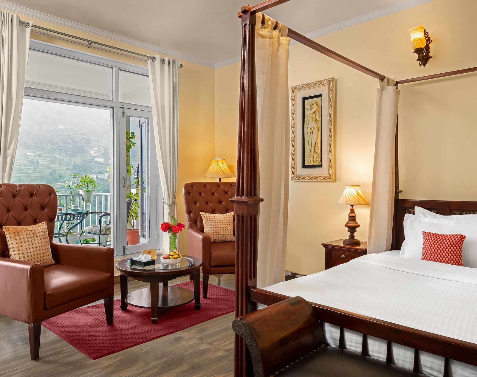 Elegant bedroom with a cosy seating area and a mountain-view balcony at BluSalzz Collection - Suvaasa Resort, Ramgarh.
