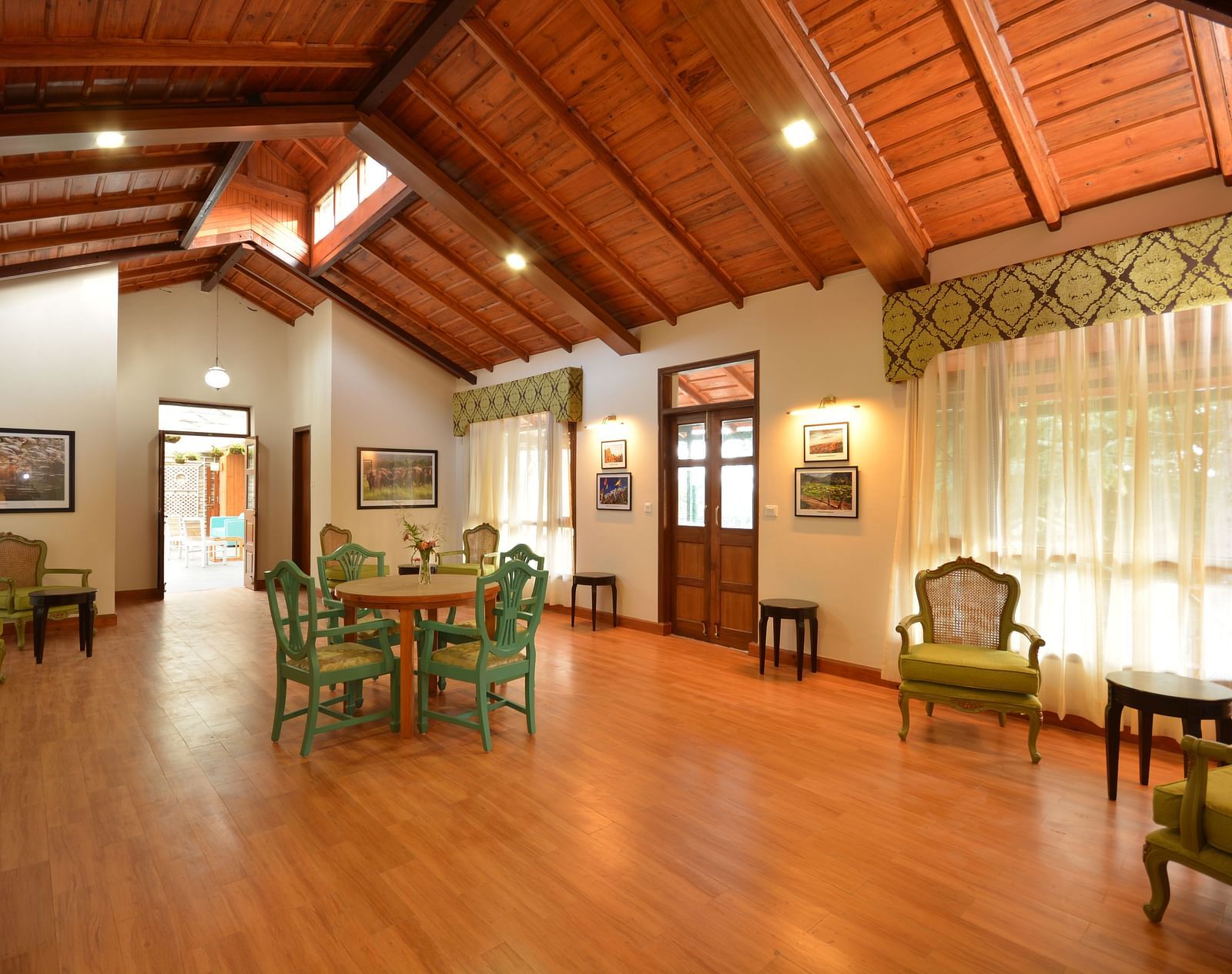 A brightly-lit hall in Almora with vintage-style furnishings and large windows - BluSalzz Escapade - Anant Rasa Resort