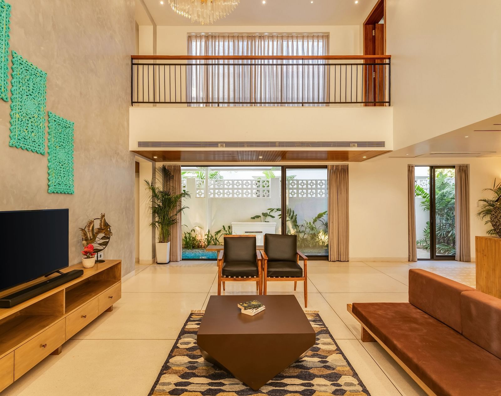 A spacious living room with high ceilings, modern decor, and large windows flooding the space with natural light - BluSalzz Villas - Alocassia, Anjuna