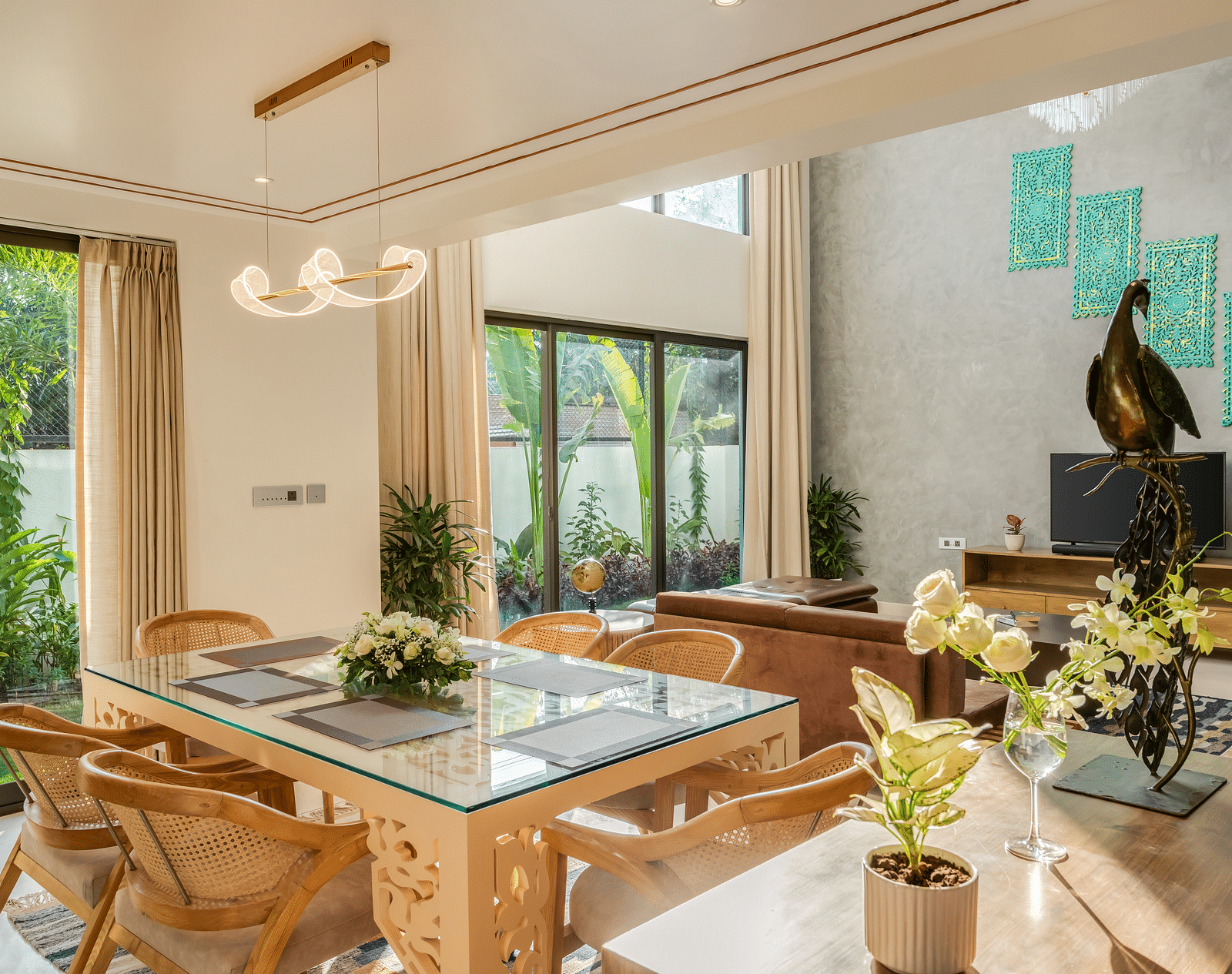 A contemporary dining area featuring a large wooden table, stylish chairs, and abundant natural light streaming through the windows.