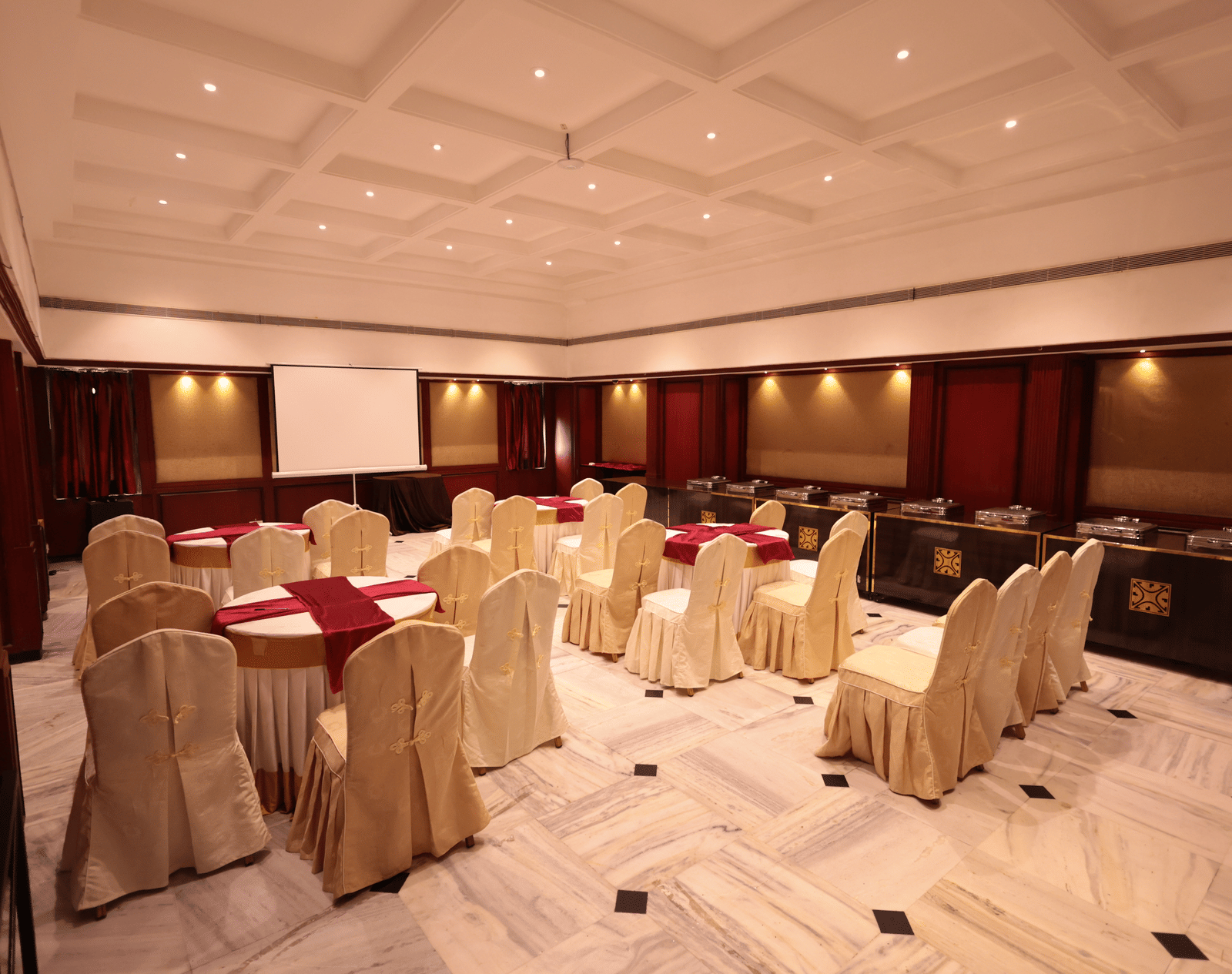 A banquet hall view from behind, with decorated tables and chairs at Cenneys Gateway.
