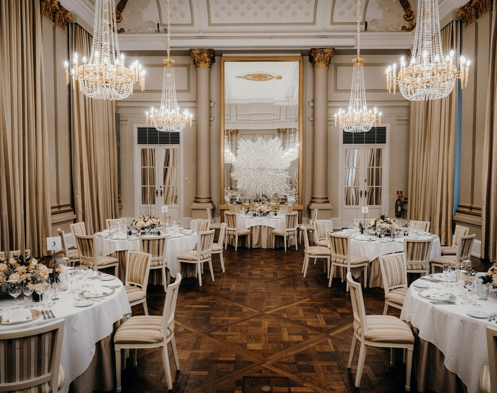 A banquet hall with neatly decorated tables and chairs.