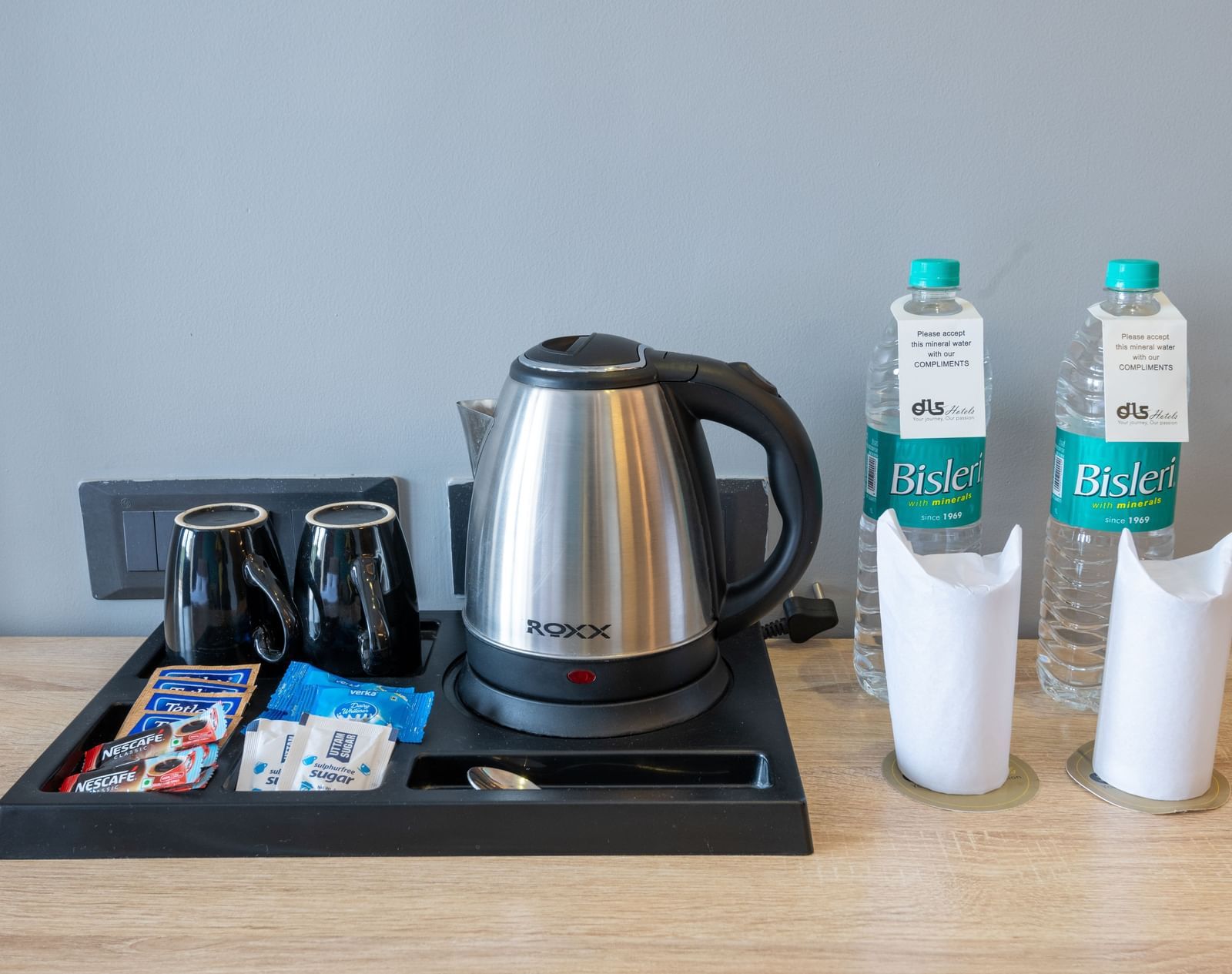 In-room tea and coffee setup with kettle, cups, and bottled water - DLS Forest Vines Resort & Spa, Ramnagar (Jim Corbett)