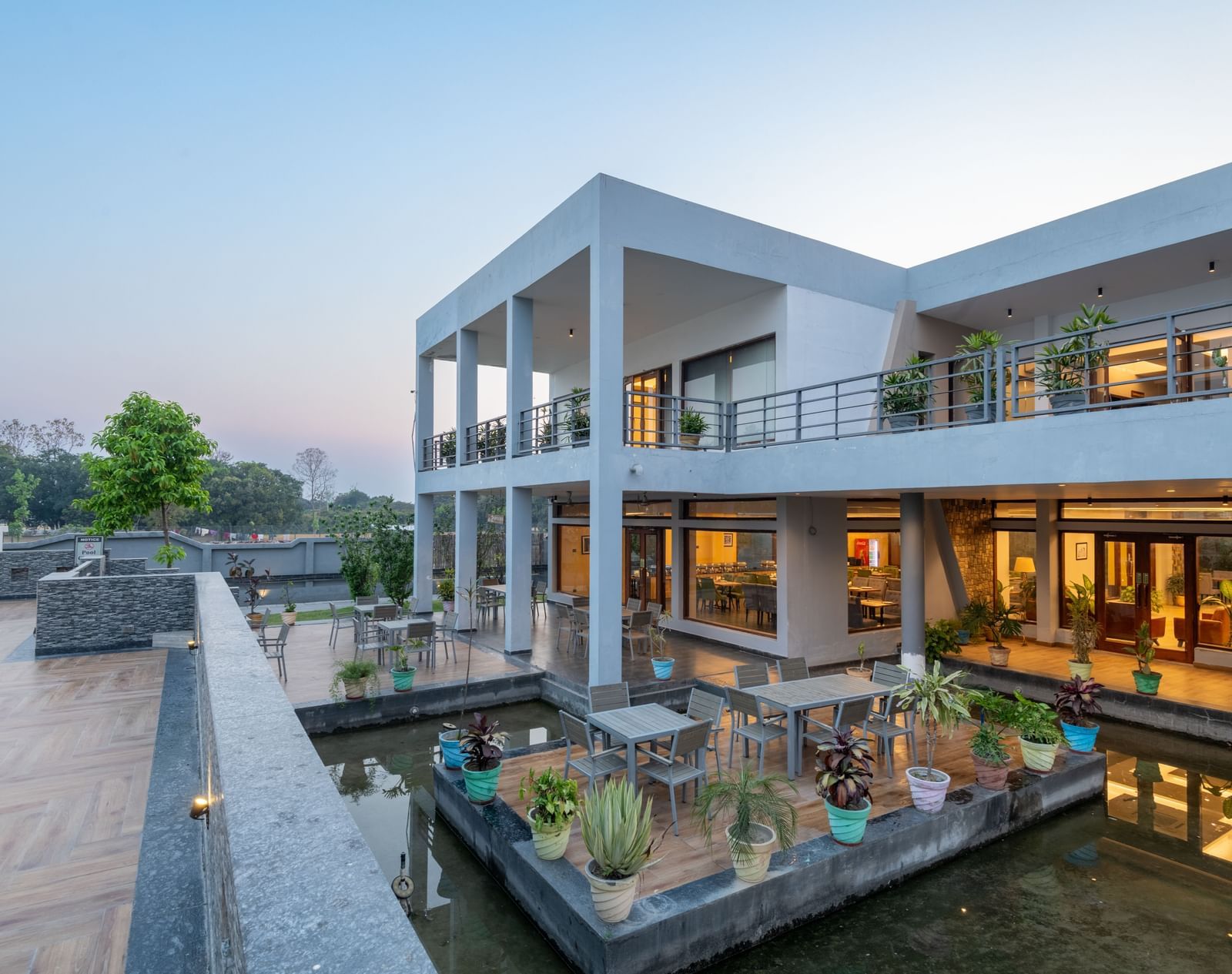 DLS Forest Vines Resorts facade bathed in the soft glow of warm lights from its windows and doors.