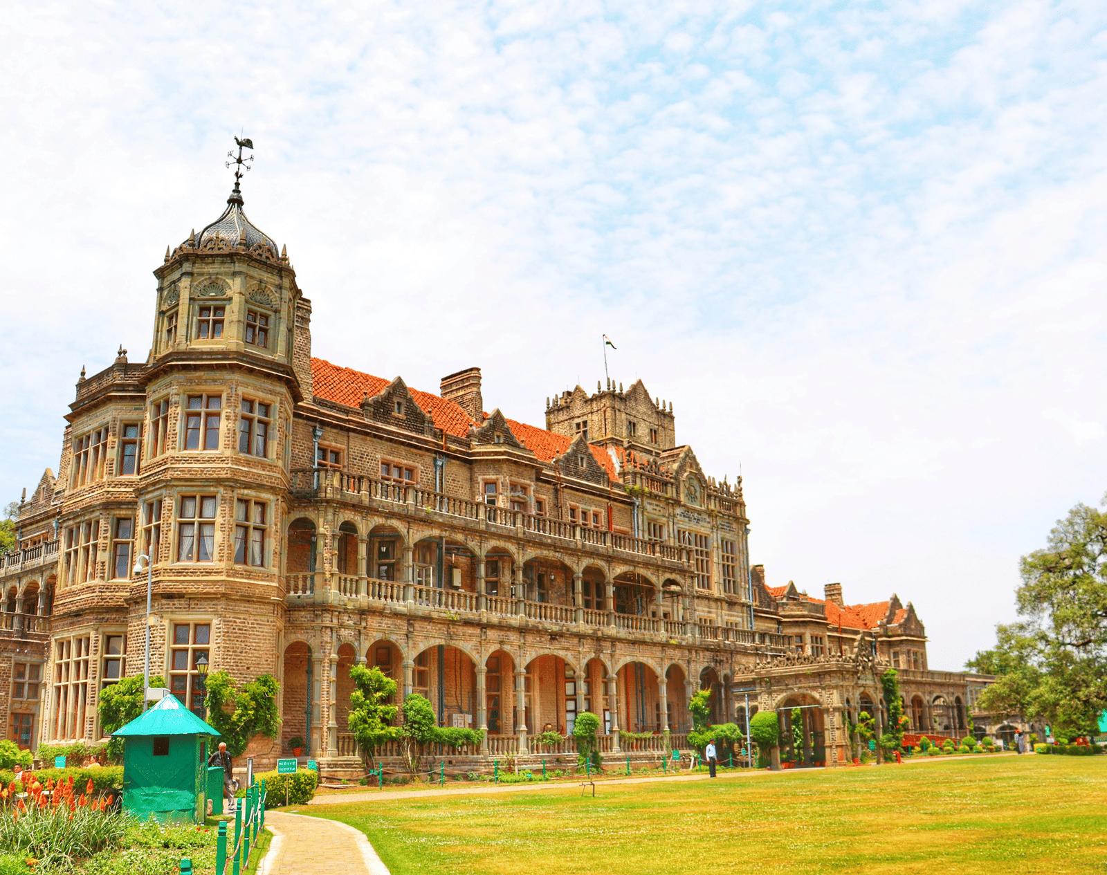 The historic viceregal lodge with intricate architecture and green lawn in front