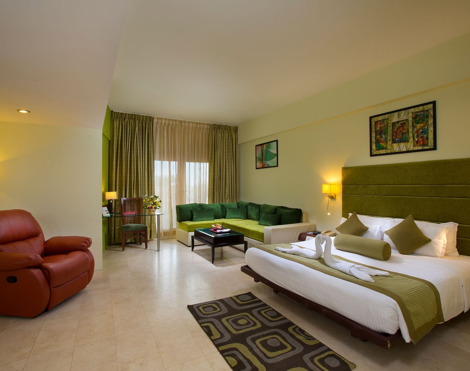 Family suite featuring a bed, a sofa and recliner at Hotel Atithi - TGI Grand, Pondicherry